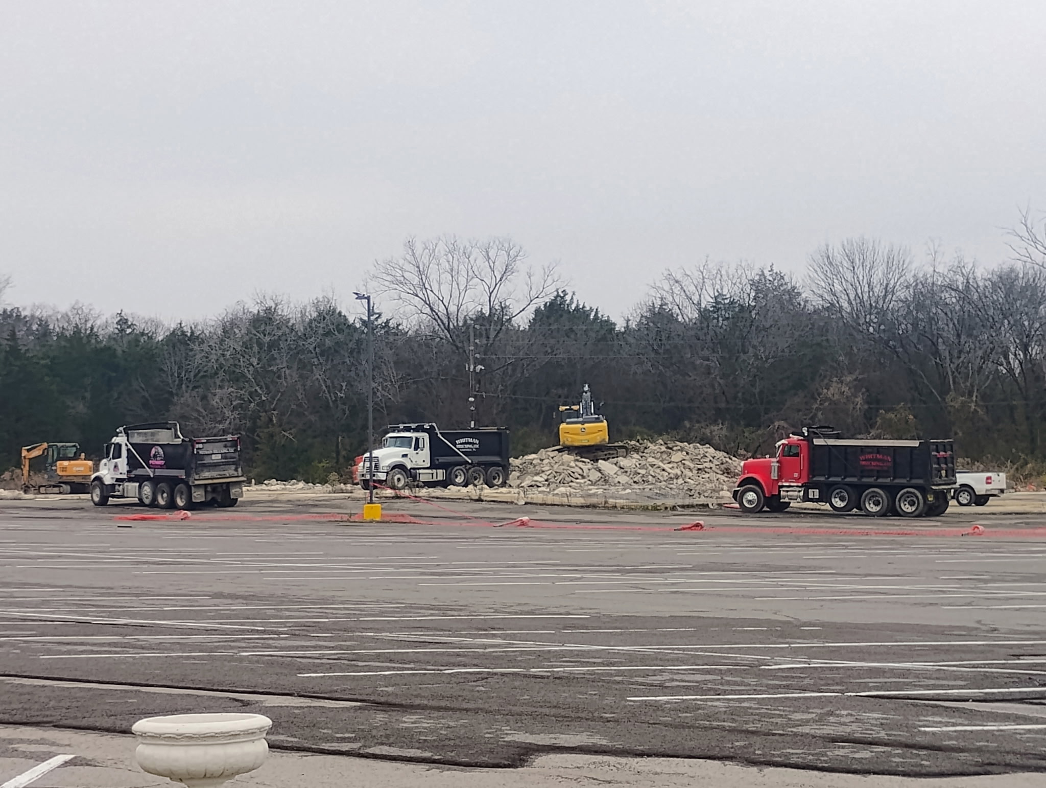 Excavation equipment and hauling trucks working across a large site